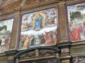 Painting of Saint Mary over the altar in San Maurizio church. That is Baby Jesus below her feet, acting somewhat like an angel, bird or in all probability, a fighter pilot.