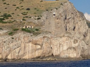 Old defensive tower with relatively new lighthouse on a point of land at one end of the Amalfi Coast