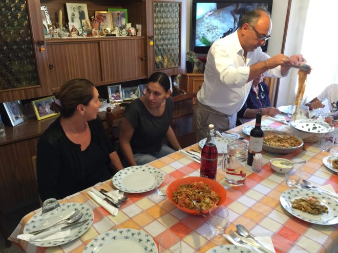 Vincenzo serves the pasta; daughter Anna to his left