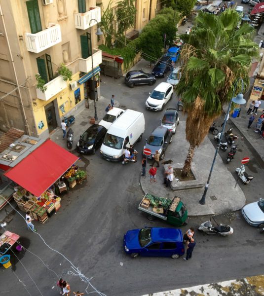 Add in a delivery truck - how do they do it. Never a fight, never any road rage, and rarely even a horn. Check the parking position of the blue car in the foreground, and the scooter going to wrong way.