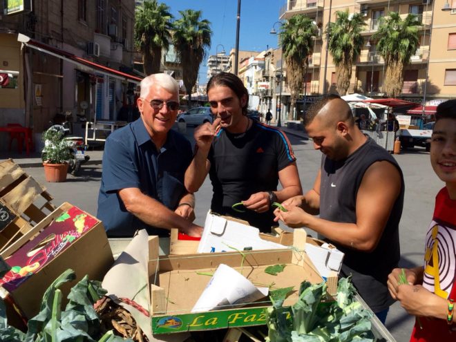 Jim, Salvo, Franko and Cristan prepare beans for cooking right on the street.