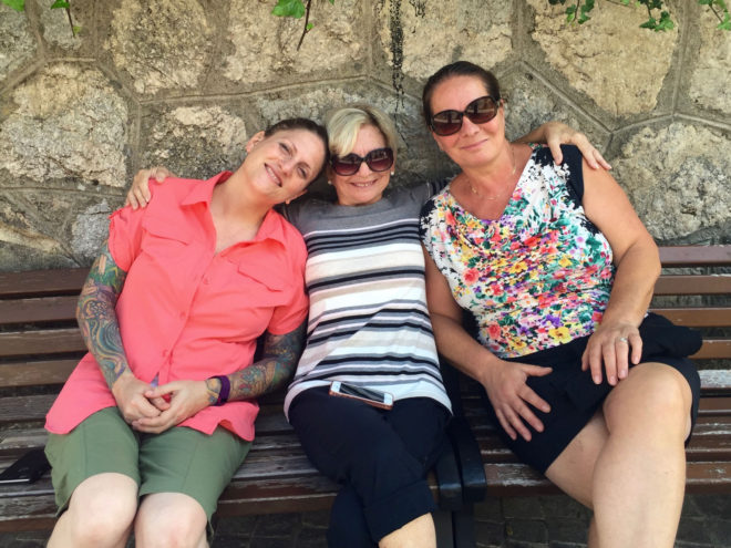 The girls - Michele, Connie and Gabriella -- on the bench outside Adolfo and Maria's houses