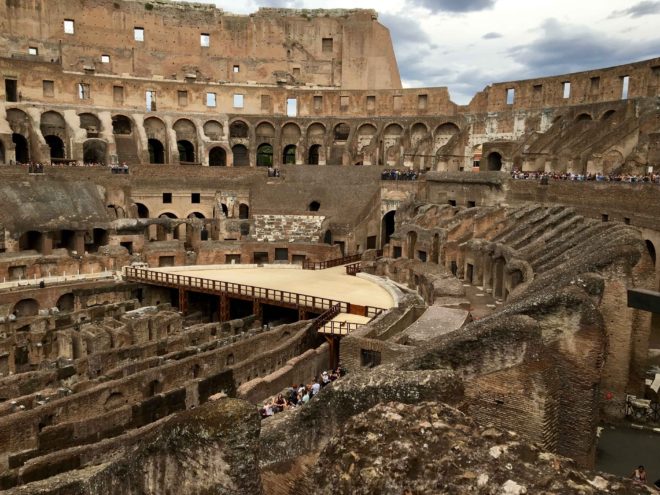 Inside the Colosseo. That tan platform is a reconstruction of where the actual "stage" or "fighting field" was located. The structure below that level was for moving gladiators, animals, support teams or in some cases, water for the spectacles. 