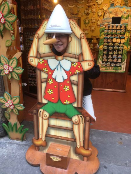 As we left the leather shore, we happened on a shop full of Pinochio knick knacks, and the posing chair -- with Fran in it!