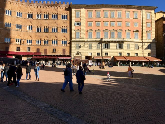 Center of the Piazza di Campo looking out. The race track for the horses is inside the buildings but outside the stone posts you can barely see. The awnings, tables and chairs are all removed and that track area is filled with clay and dirt for the race.