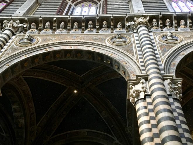 One section showing 10 busts of the 172 busts of Popes that line the upper level of the walls.