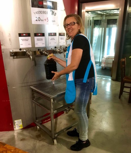 The negozio, or store, where Adolfo and Gabriella buy their Montepulciano d'Abruzzo wine. Giant vat with the wines of Abruzzo, and plastic containers.