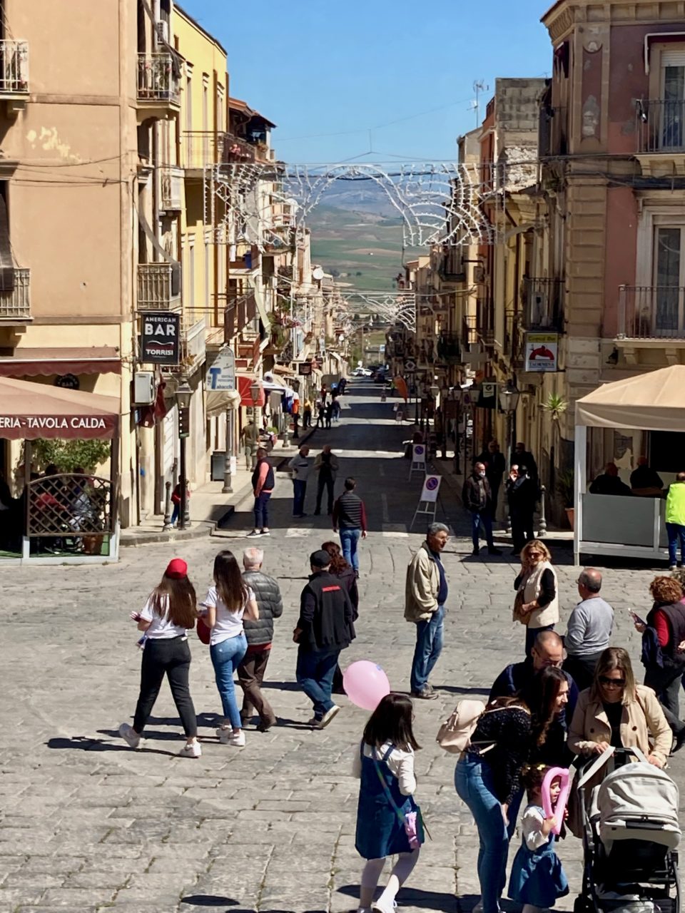 long street w/people in plaza